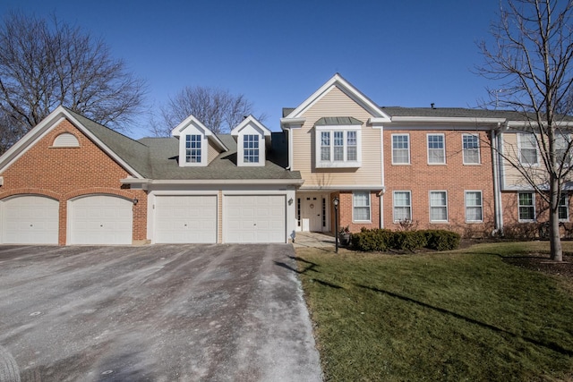 view of front of house with a garage and a front lawn