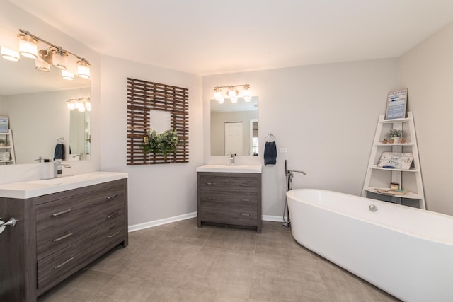 bathroom with vanity, tile patterned floors, and a bathtub