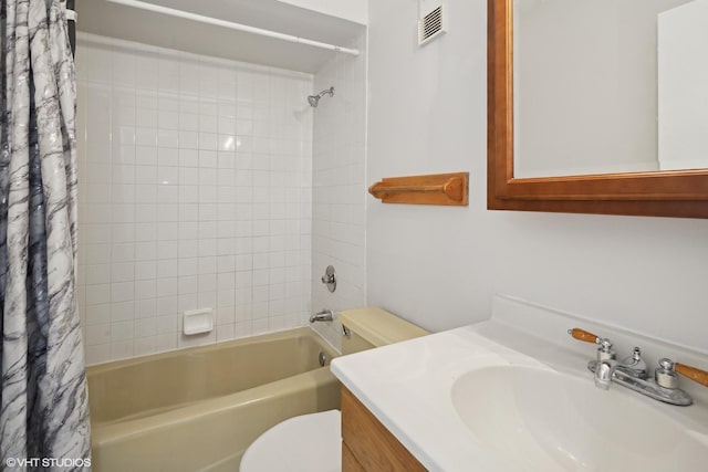 full bathroom featuring vanity, shower / tub combo, and toilet