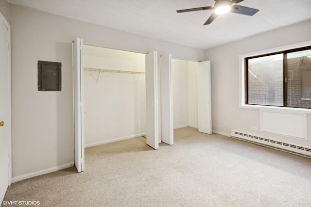 unfurnished bedroom with baseboard heating, ceiling fan, electric panel, and light carpet