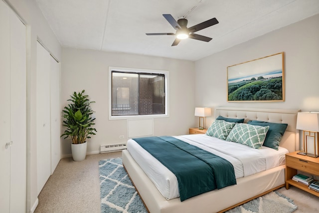 carpeted bedroom with a baseboard heating unit and ceiling fan