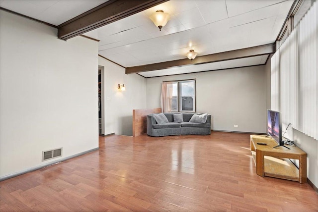 living room featuring beam ceiling and light hardwood / wood-style flooring