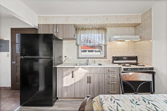 kitchen featuring sink, crown molding, black refrigerator, white range with gas cooktop, and light hardwood / wood-style floors