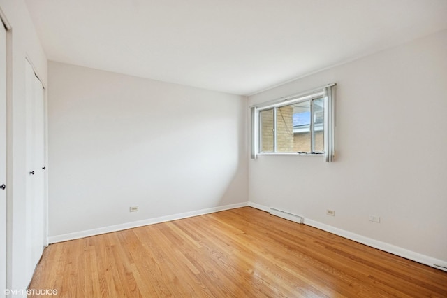 unfurnished bedroom featuring visible vents, light wood-type flooring, and baseboards