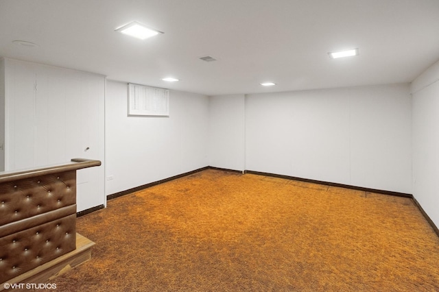 finished basement featuring visible vents, baseboards, and carpet