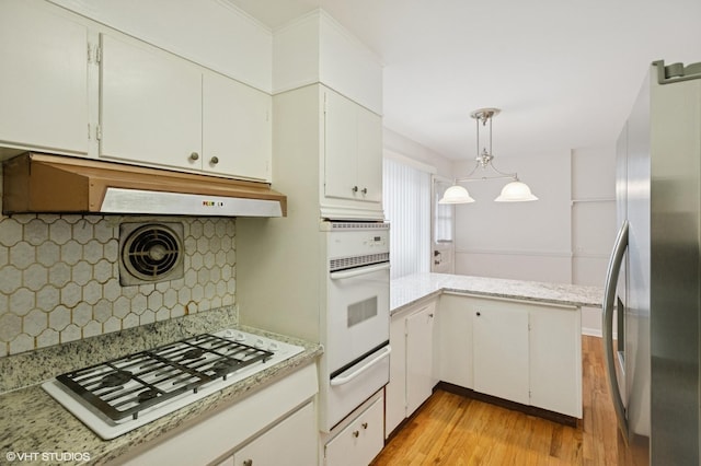 kitchen featuring a warming drawer, under cabinet range hood, white appliances, light wood-style floors, and white cabinets