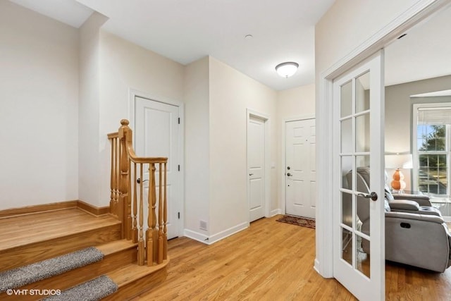 corridor with french doors and light wood-type flooring