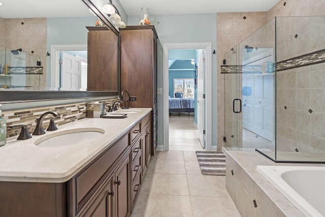 bathroom featuring tile patterned flooring, vanity, separate shower and tub, and tasteful backsplash