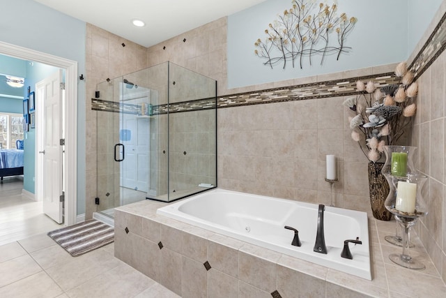 bathroom featuring plus walk in shower and tile patterned flooring