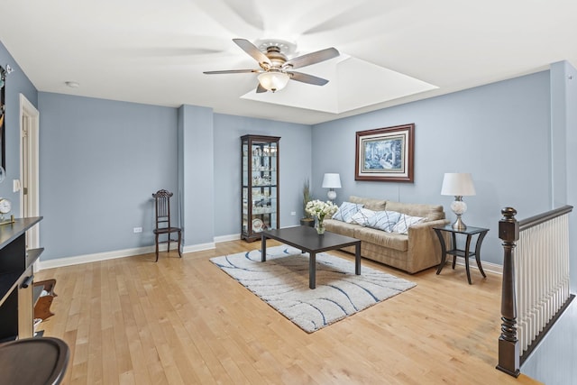 living room featuring ceiling fan and light hardwood / wood-style floors