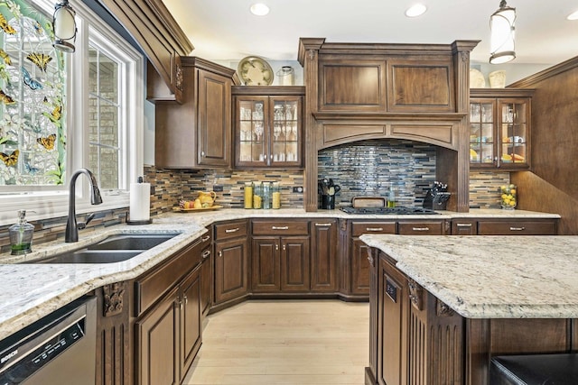 kitchen with pendant lighting, sink, decorative backsplash, and stainless steel dishwasher