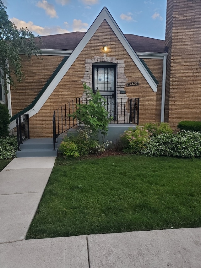 view of exterior entry with a yard