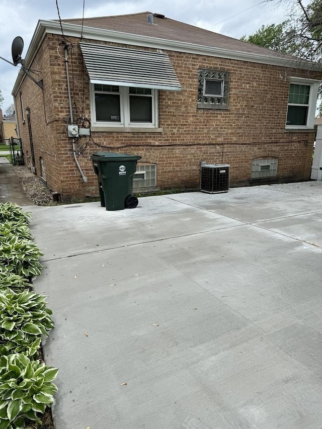 view of home's exterior with central AC unit and a patio area