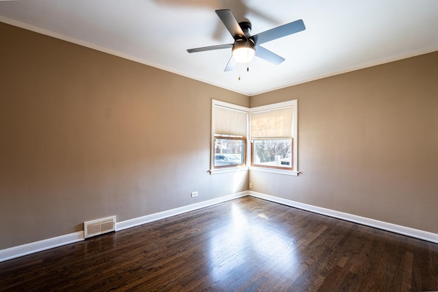 empty room with crown molding, ceiling fan, and dark hardwood / wood-style flooring