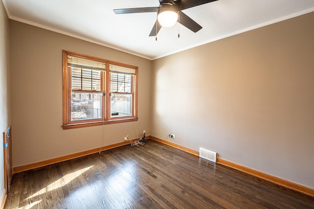 empty room with crown molding, dark hardwood / wood-style floors, and ceiling fan