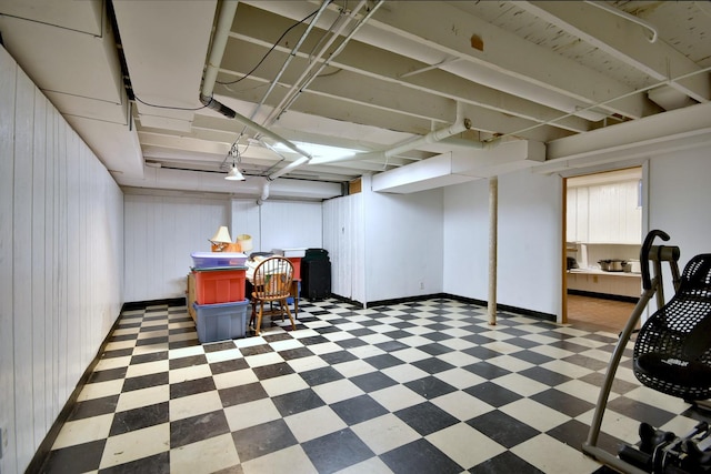 finished below grade area featuring dark floors and baseboards