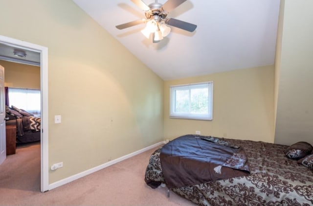 bedroom with light carpet, vaulted ceiling, and ceiling fan