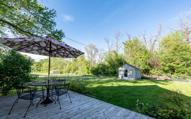 deck featuring a storage unit and a yard