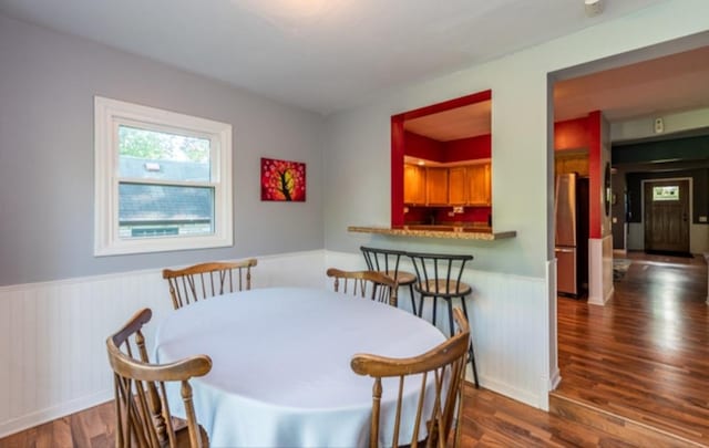 dining space with dark hardwood / wood-style floors