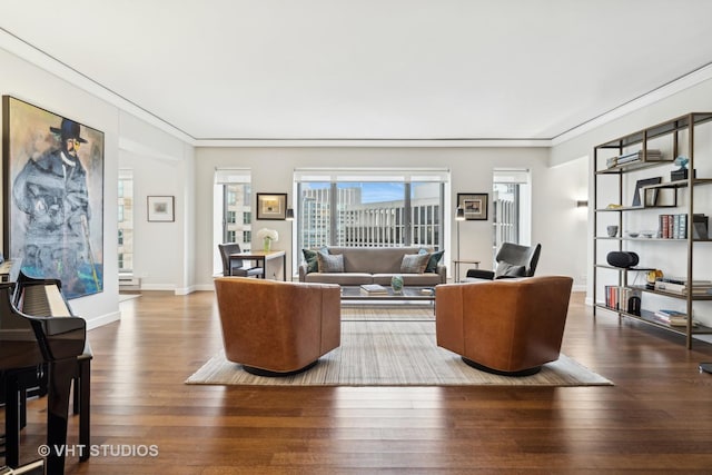 living room with hardwood / wood-style floors and crown molding