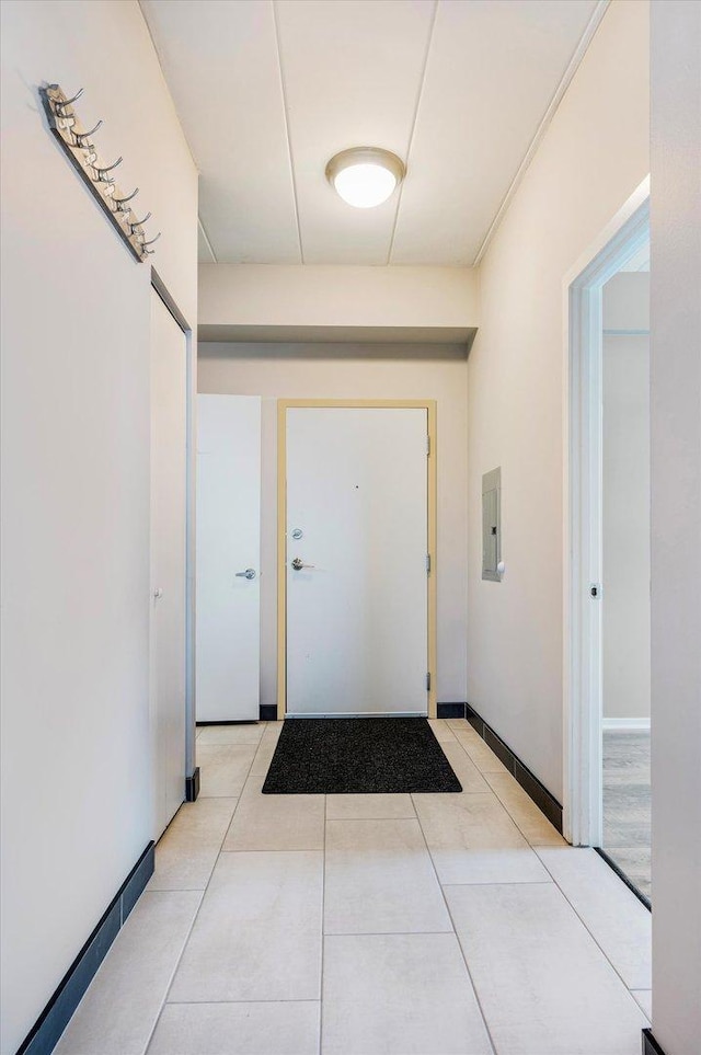 entryway with light tile patterned floors and electric panel