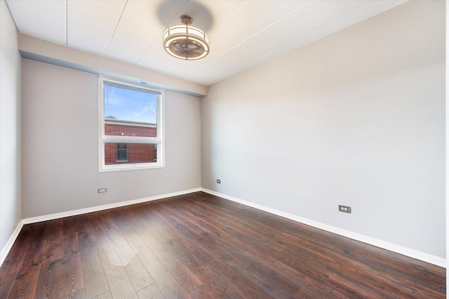 unfurnished room with dark wood-type flooring