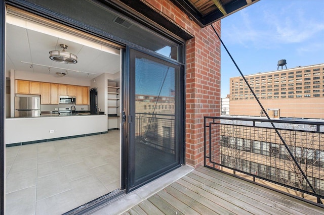 balcony with an outdoor kitchen and sink