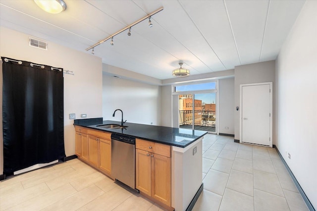 kitchen featuring rail lighting, sink, fridge, stainless steel dishwasher, and kitchen peninsula