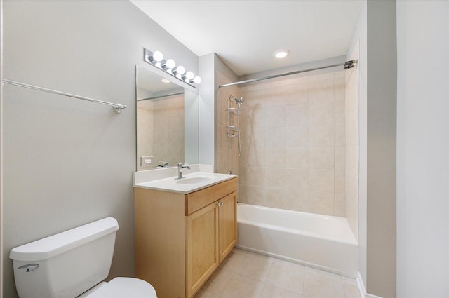 full bathroom featuring vanity, tiled shower / bath combo, and toilet