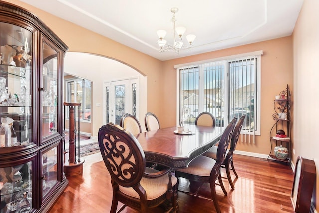 dining space featuring hardwood / wood-style flooring and a notable chandelier