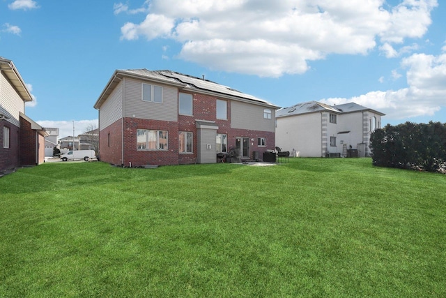 rear view of property featuring a lawn