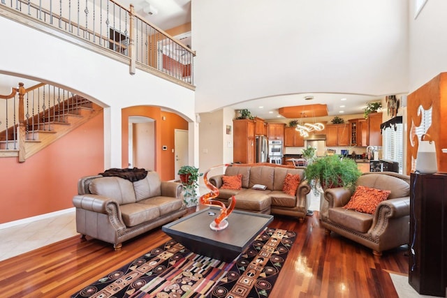 living room featuring dark hardwood / wood-style flooring and a towering ceiling