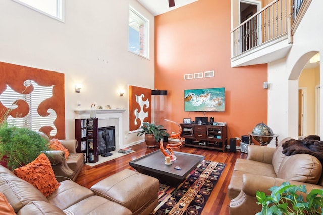 living room featuring hardwood / wood-style floors and a towering ceiling