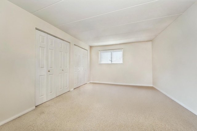 unfurnished bedroom with multiple closets