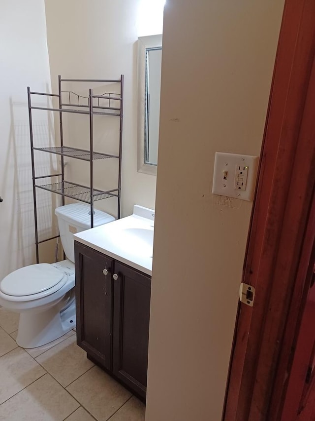 bathroom featuring vanity, toilet, and tile patterned flooring