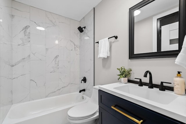 full bathroom featuring tiled shower / bath, vanity, and toilet