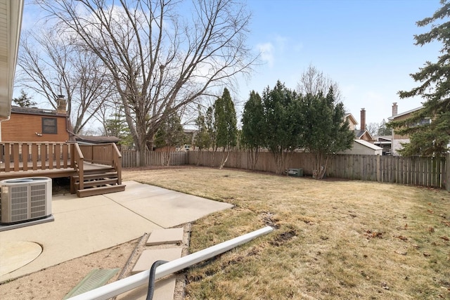 view of yard with cooling unit, a wooden deck, and a patio