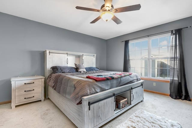 bedroom featuring light carpet and ceiling fan