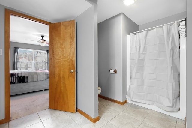 bathroom featuring toilet, tile patterned floors, ceiling fan, and a shower with shower curtain