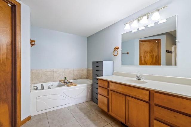 bathroom with tile patterned flooring, vanity, and a bathtub