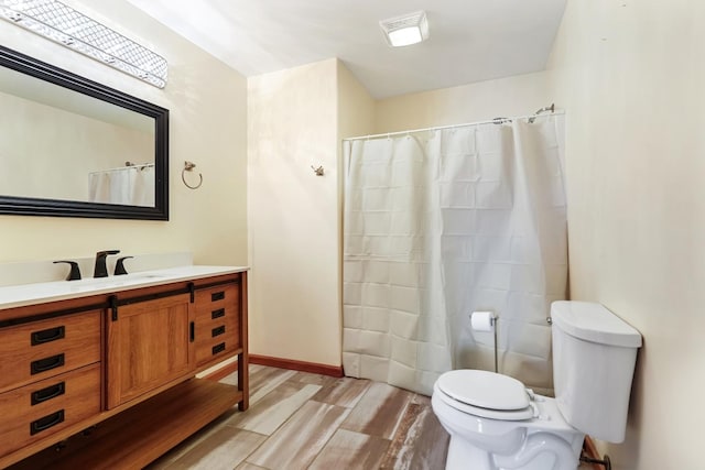 bathroom with vanity, wood-type flooring, and toilet