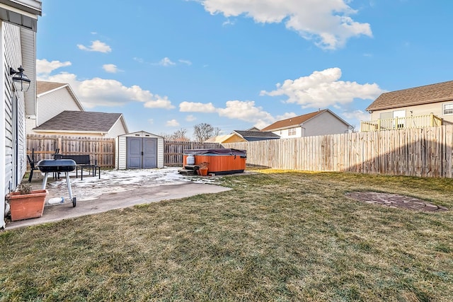 view of yard with a storage unit, a hot tub, and a patio area