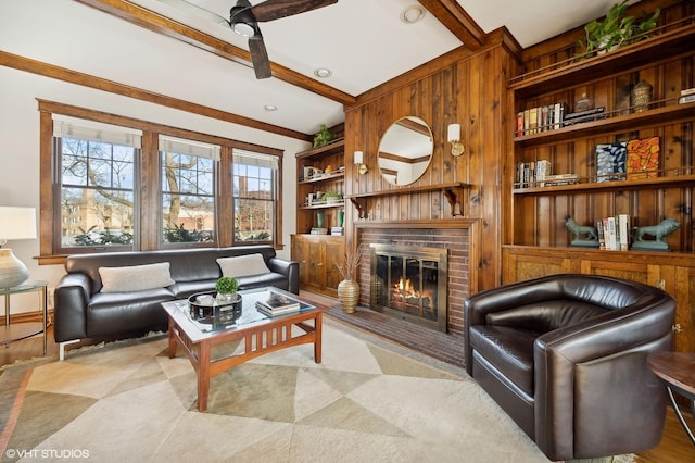 living room featuring a brick fireplace and beamed ceiling