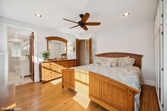 bedroom featuring connected bathroom, ceiling fan, and light hardwood / wood-style floors