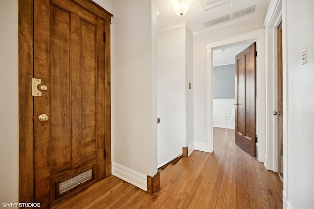 hallway with light hardwood / wood-style floors