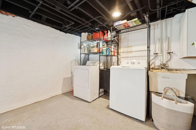 washroom with sink and washer and dryer