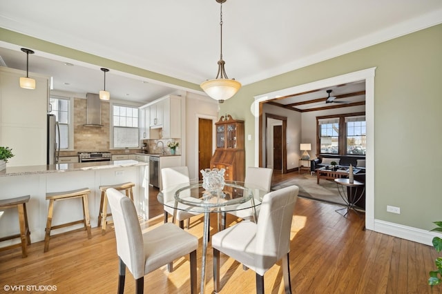 dining room featuring sink, light hardwood / wood-style flooring, and ceiling fan