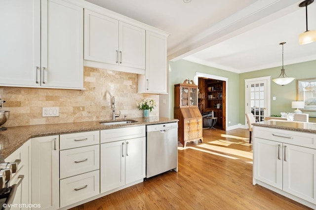 kitchen with sink, white cabinetry, light hardwood / wood-style flooring, stainless steel dishwasher, and pendant lighting