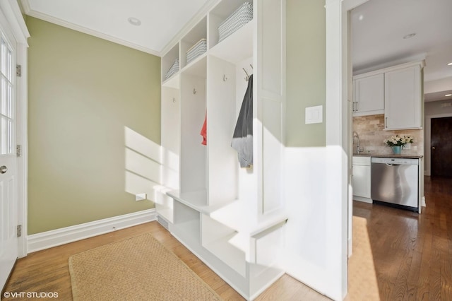 mudroom featuring sink, crown molding, and hardwood / wood-style flooring