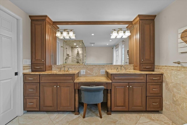 bathroom featuring vanity, a shower with door, and tile walls